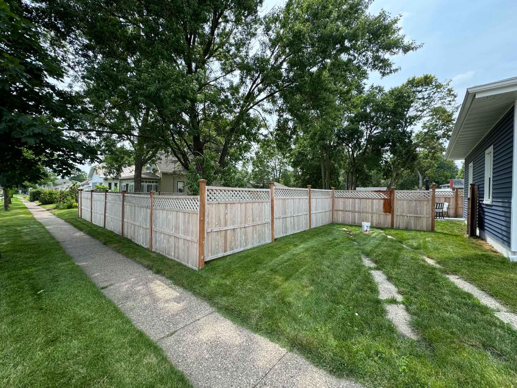Fence Restoration 16 A Fence Partially Stained In A Yard