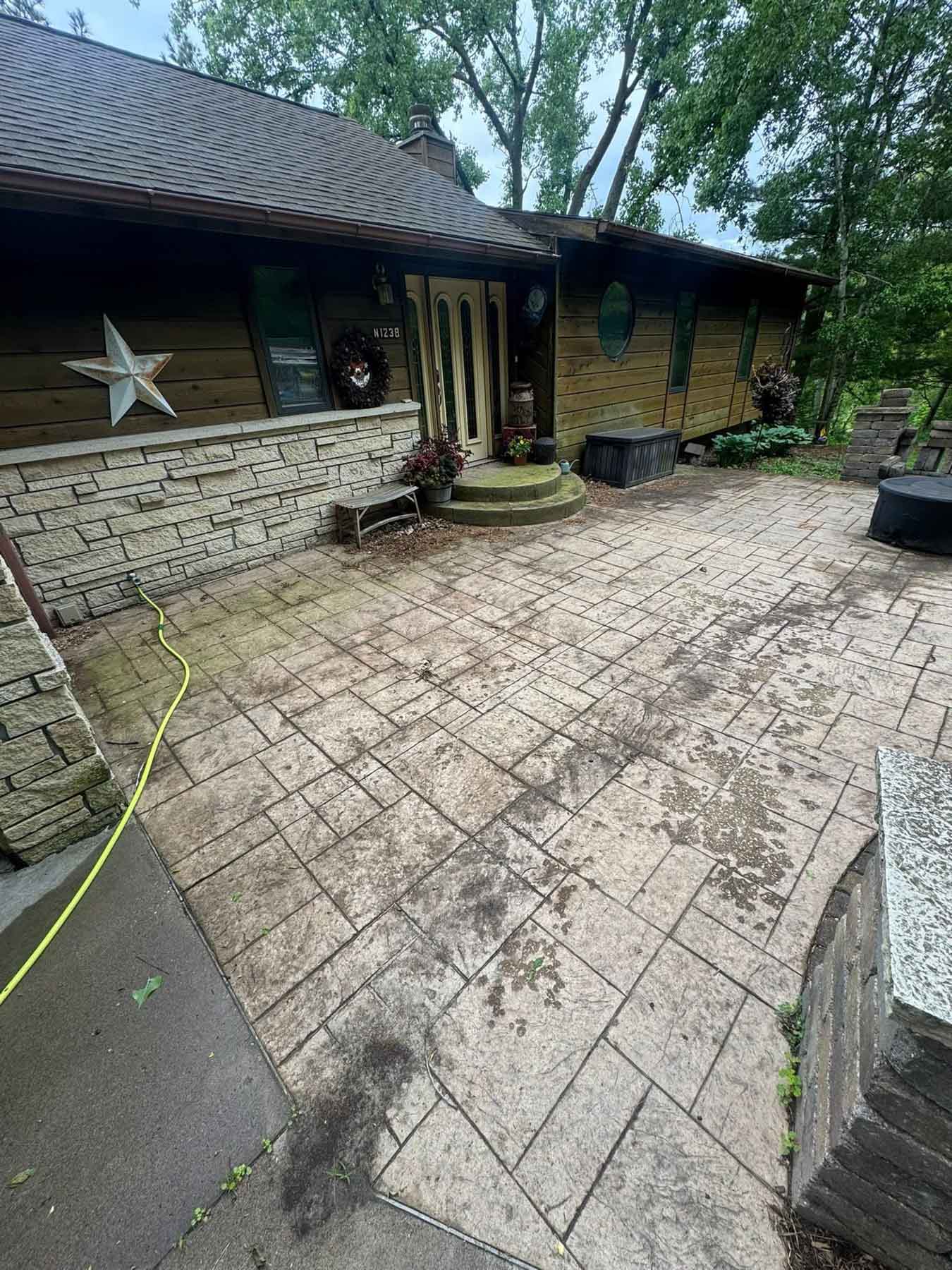 Paver Cleaning 46 Patio Before Being Cleaned By Driftless Exteriors